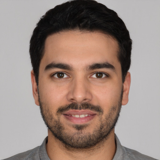 Joyful white young-adult male with short  black hair and brown eyes