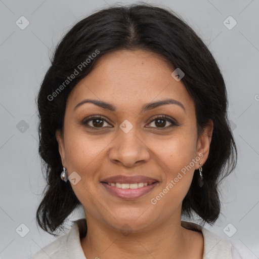 Joyful latino adult female with medium  brown hair and brown eyes