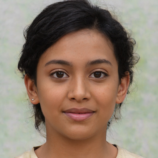 Joyful latino young-adult female with medium  brown hair and brown eyes
