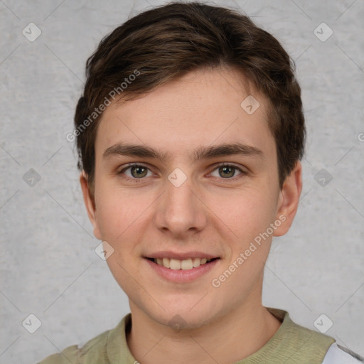 Joyful white young-adult male with short  brown hair and grey eyes