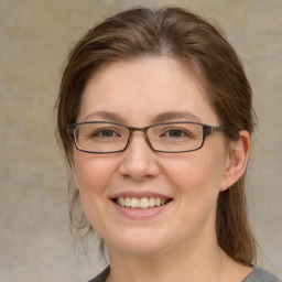 Joyful white adult female with medium  brown hair and grey eyes