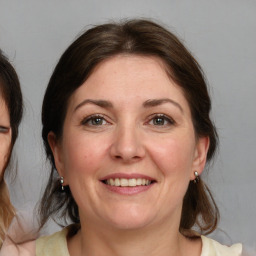 Joyful white adult female with medium  brown hair and brown eyes