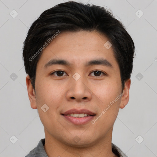 Joyful asian young-adult male with short  black hair and brown eyes