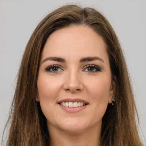 Joyful white young-adult female with long  brown hair and brown eyes