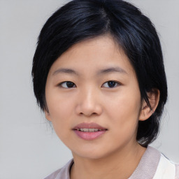 Joyful asian young-adult female with medium  black hair and brown eyes