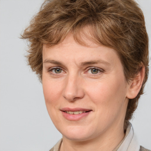 Joyful white adult female with medium  brown hair and grey eyes