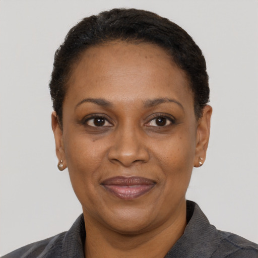 Joyful black adult female with short  black hair and brown eyes