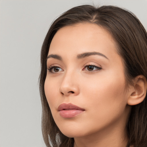 Neutral white young-adult female with long  brown hair and brown eyes