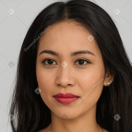 Joyful latino young-adult female with long  brown hair and brown eyes