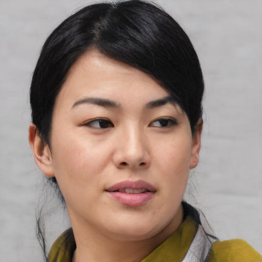 Joyful asian young-adult female with medium  black hair and brown eyes