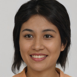 Joyful asian young-adult female with medium  brown hair and brown eyes