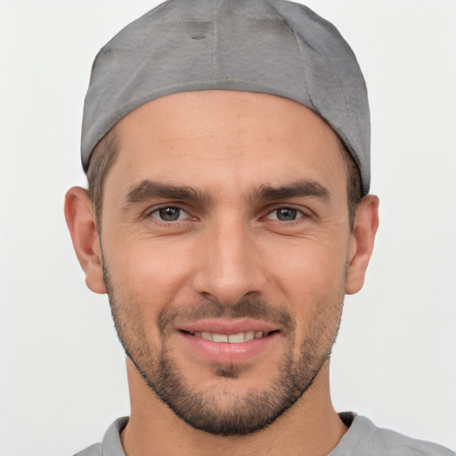 Joyful white young-adult male with short  black hair and brown eyes