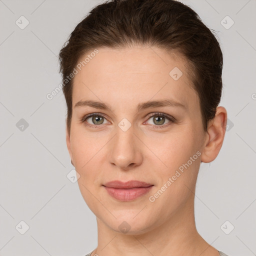 Joyful white young-adult female with short  brown hair and grey eyes