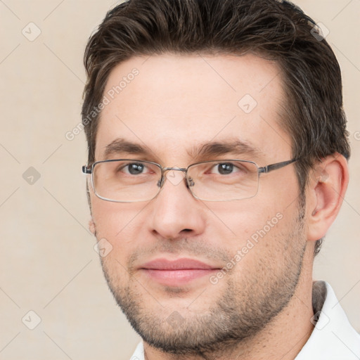 Joyful white adult male with short  brown hair and brown eyes