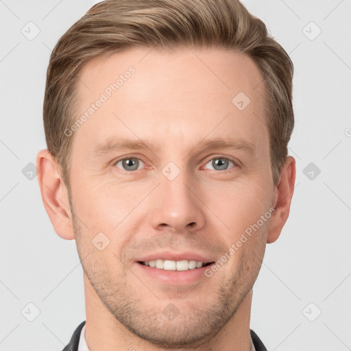 Joyful white young-adult male with short  brown hair and grey eyes