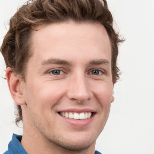 Joyful white young-adult male with short  brown hair and blue eyes