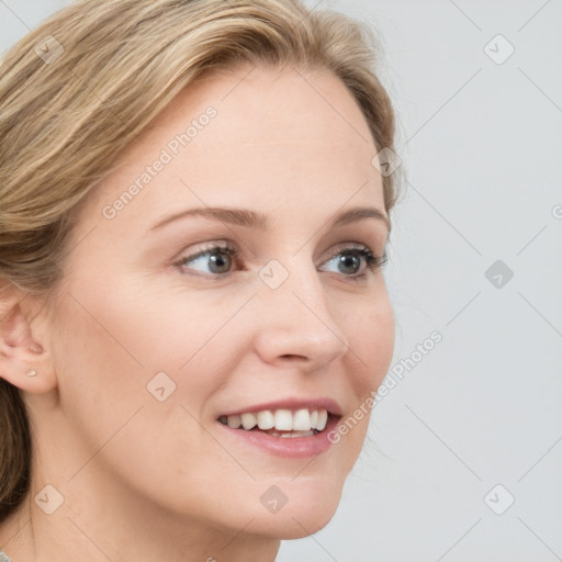 Joyful white young-adult female with long  brown hair and blue eyes