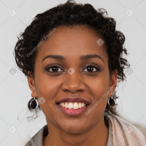 Joyful black young-adult female with long  brown hair and brown eyes