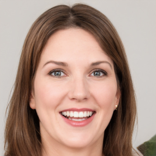 Joyful white young-adult female with medium  brown hair and grey eyes