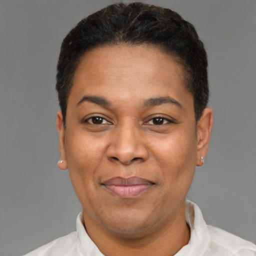 Joyful latino adult female with short  brown hair and brown eyes