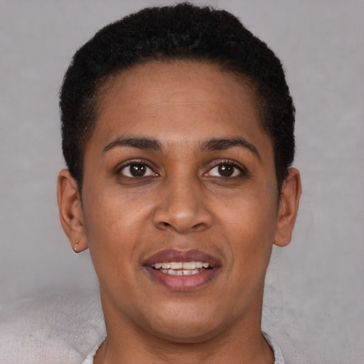 Joyful black young-adult female with short  brown hair and brown eyes
