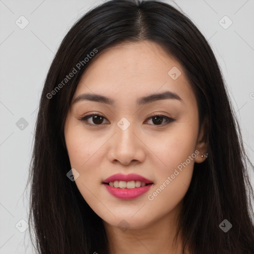 Joyful asian young-adult female with long  brown hair and brown eyes