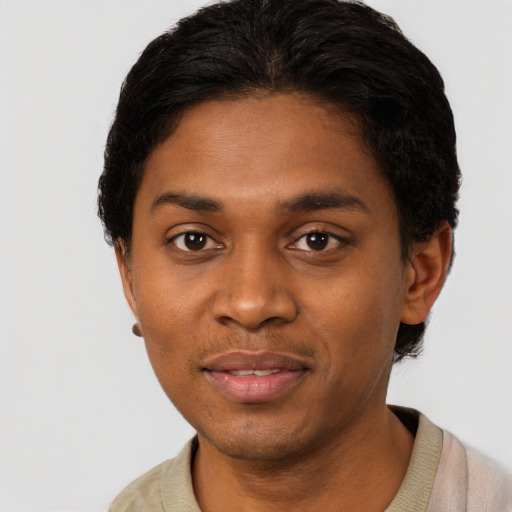 Joyful black young-adult male with short  black hair and brown eyes