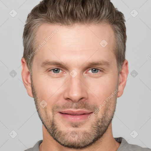 Joyful white young-adult male with short  brown hair and grey eyes