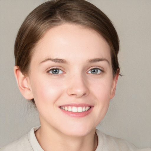 Joyful white young-adult female with short  brown hair and grey eyes