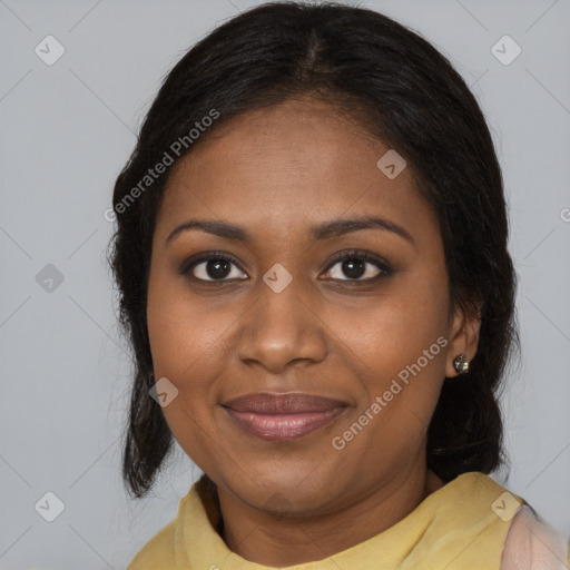 Joyful black young-adult female with long  brown hair and brown eyes