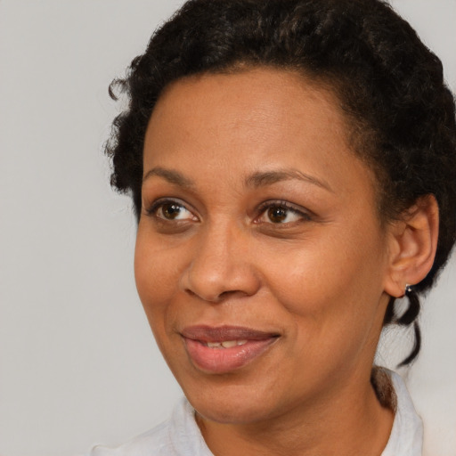 Joyful black adult female with short  brown hair and brown eyes