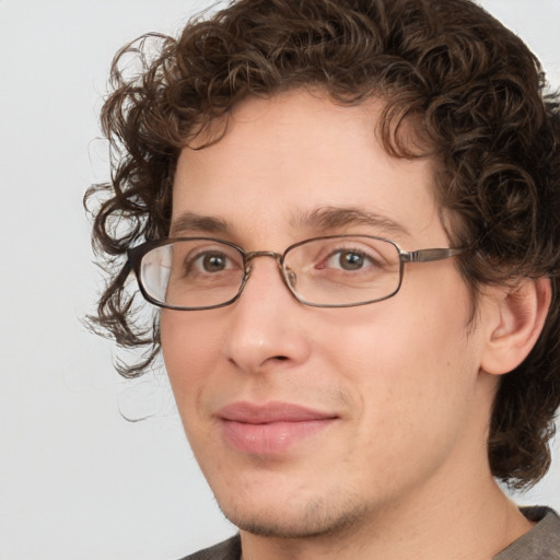 Joyful white adult male with medium  brown hair and brown eyes