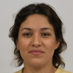 Joyful white adult female with medium  brown hair and brown eyes