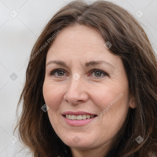 Joyful white adult female with long  brown hair and grey eyes