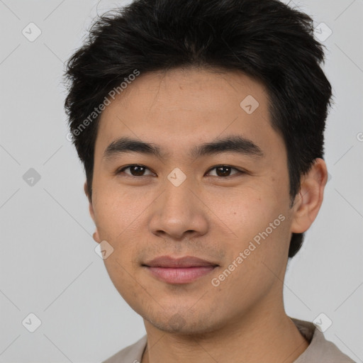 Joyful asian young-adult male with short  black hair and brown eyes