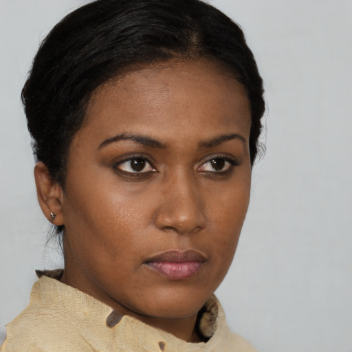 Neutral black young-adult female with medium  brown hair and brown eyes