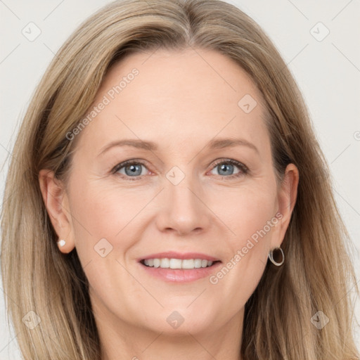 Joyful white adult female with long  brown hair and grey eyes