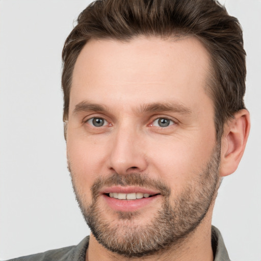 Joyful white young-adult male with short  brown hair and brown eyes