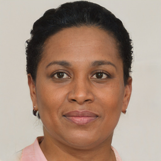Joyful black adult female with short  brown hair and brown eyes