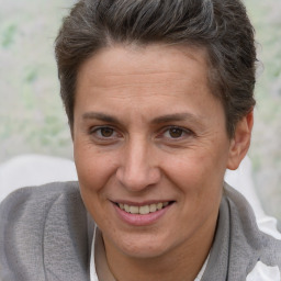 Joyful white adult female with short  brown hair and brown eyes