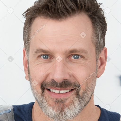 Joyful white adult male with short  brown hair and grey eyes