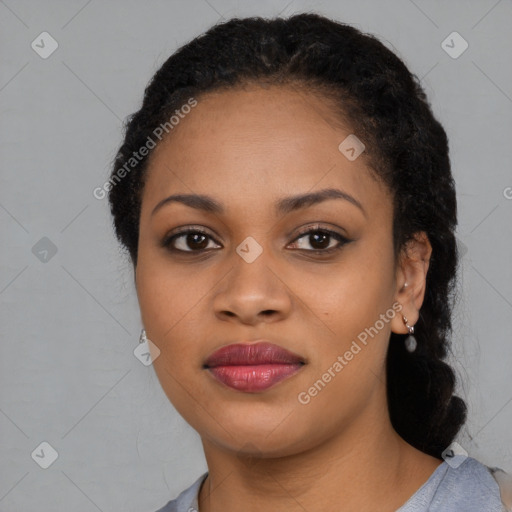 Joyful black young-adult female with long  black hair and brown eyes