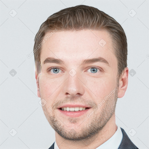 Joyful white young-adult male with short  brown hair and grey eyes