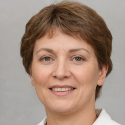 Joyful white adult female with short  brown hair and grey eyes