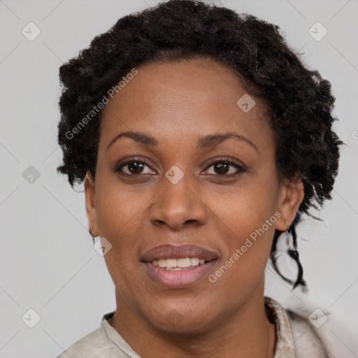 Joyful black adult female with short  brown hair and brown eyes