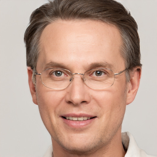 Joyful white adult male with short  brown hair and grey eyes