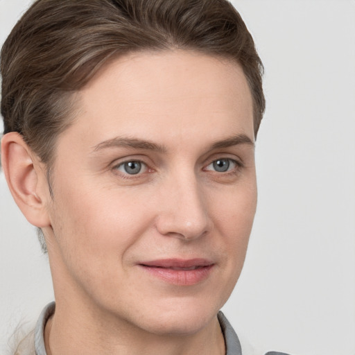 Joyful white young-adult female with short  brown hair and grey eyes