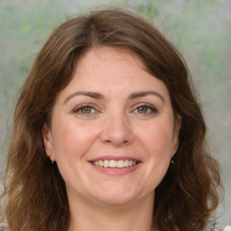 Joyful white adult female with medium  brown hair and green eyes