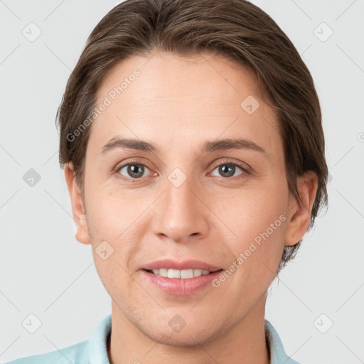 Joyful white young-adult female with short  brown hair and grey eyes