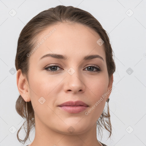 Joyful white young-adult female with medium  brown hair and grey eyes